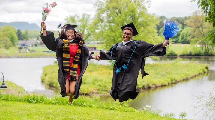 Two students jumping in the air