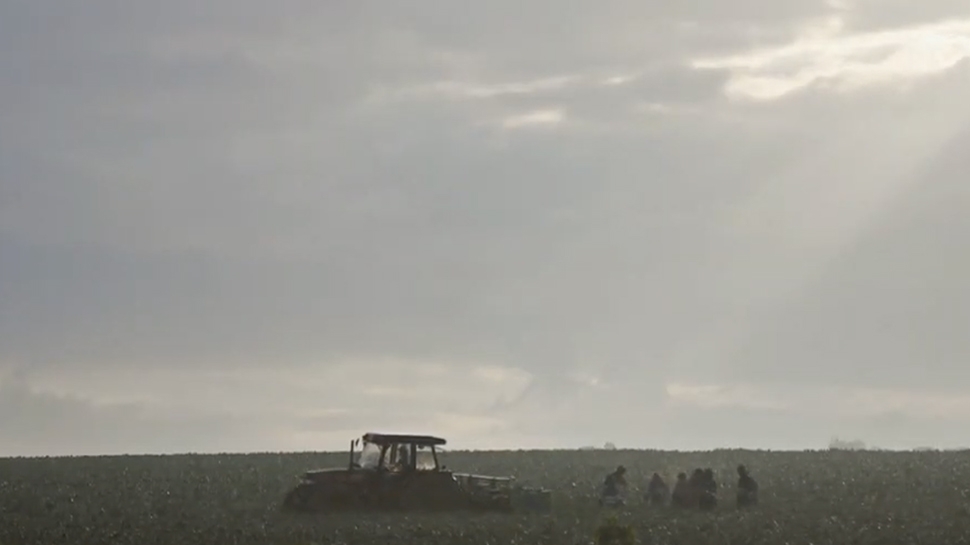 Video still of a field and tractor